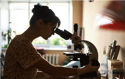 Woman looking in microscope