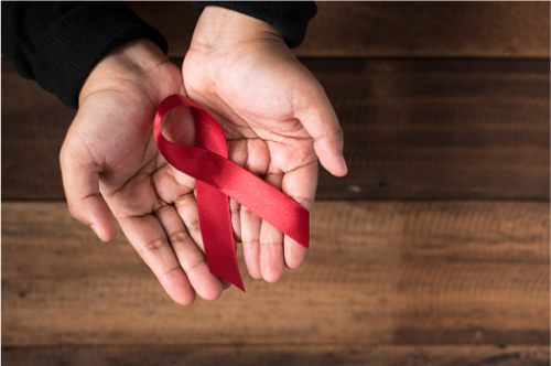 Man holding red ribbon in hands